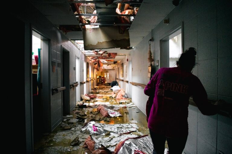 Nursing home assistant walking through damage